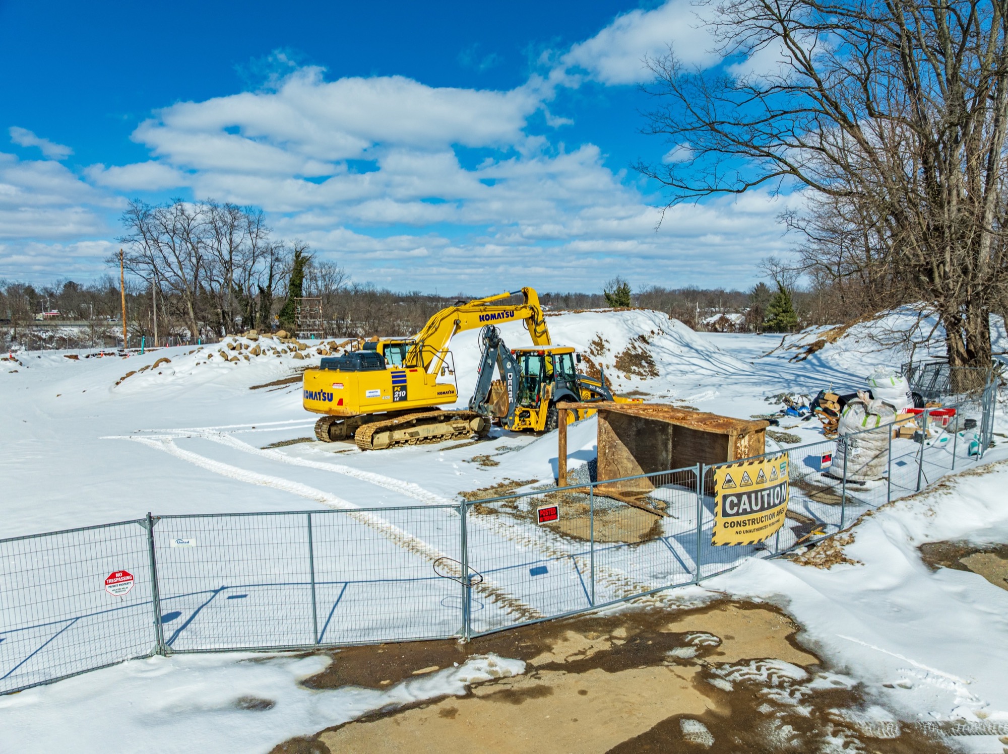 Ground-level view of equipment positioned at the snowy construction site