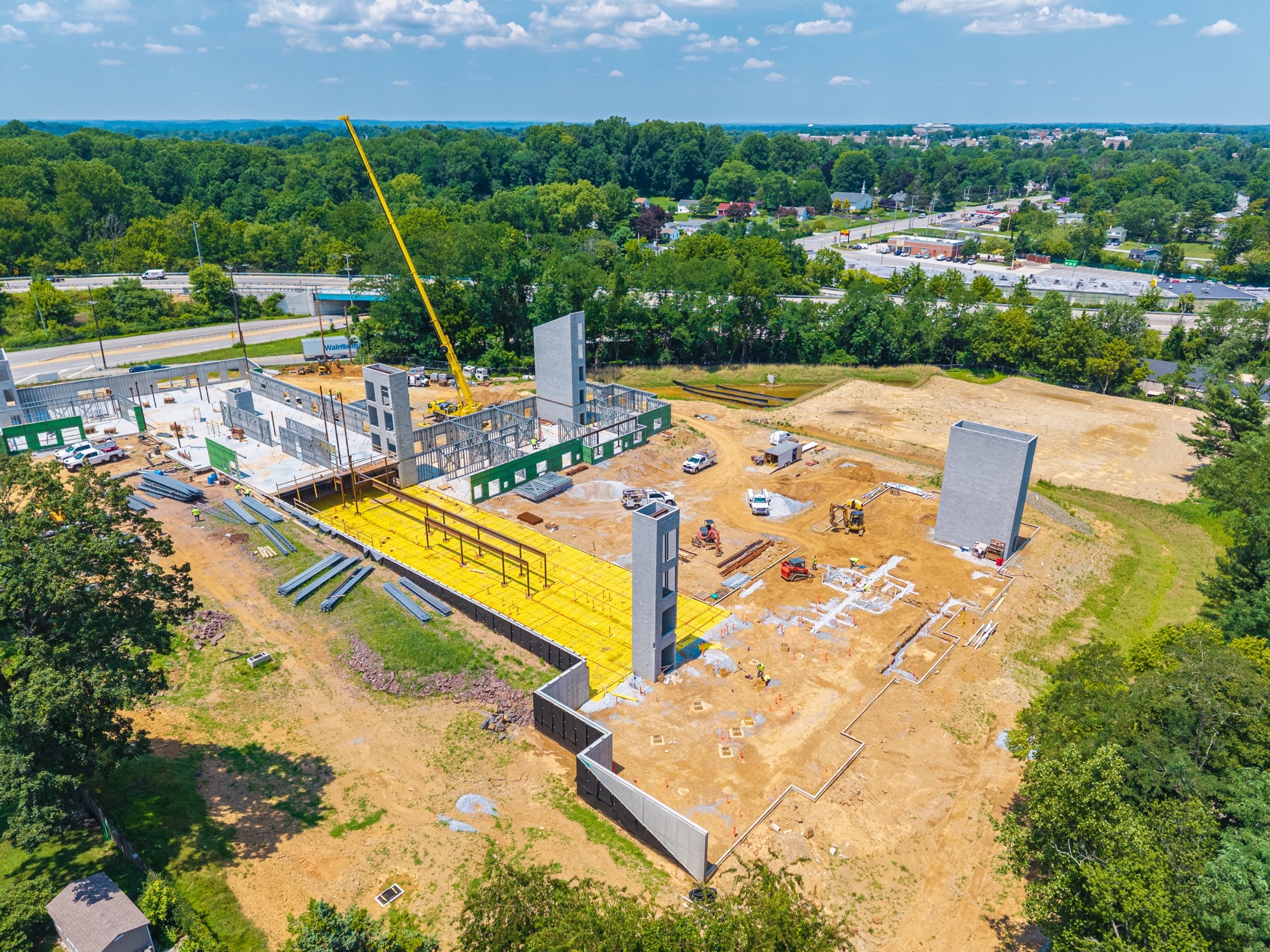 Wide aerial showing July construction progress